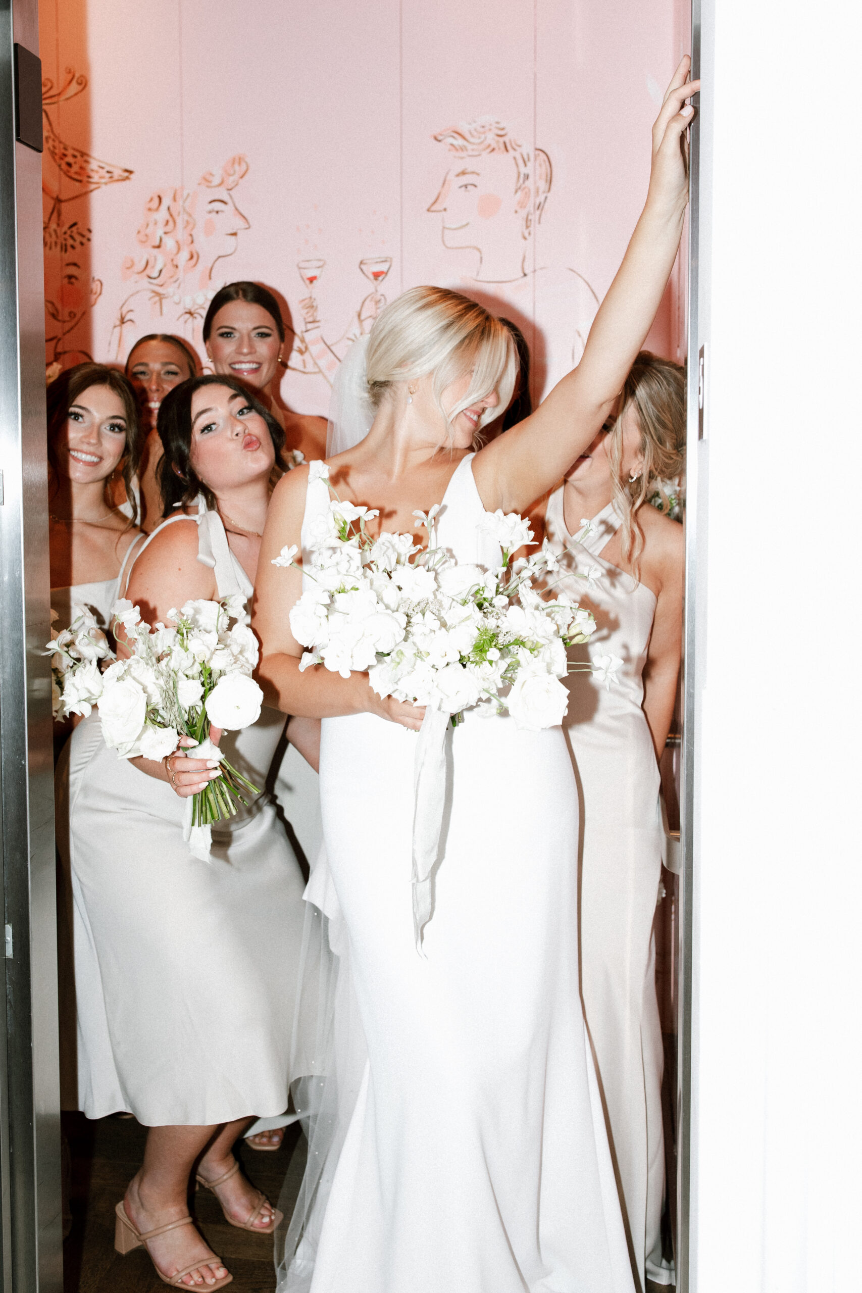 Bridal Party in Elevator and Bride Wearing 'Vivian' by Alyssa Kristin Wedding Dress
