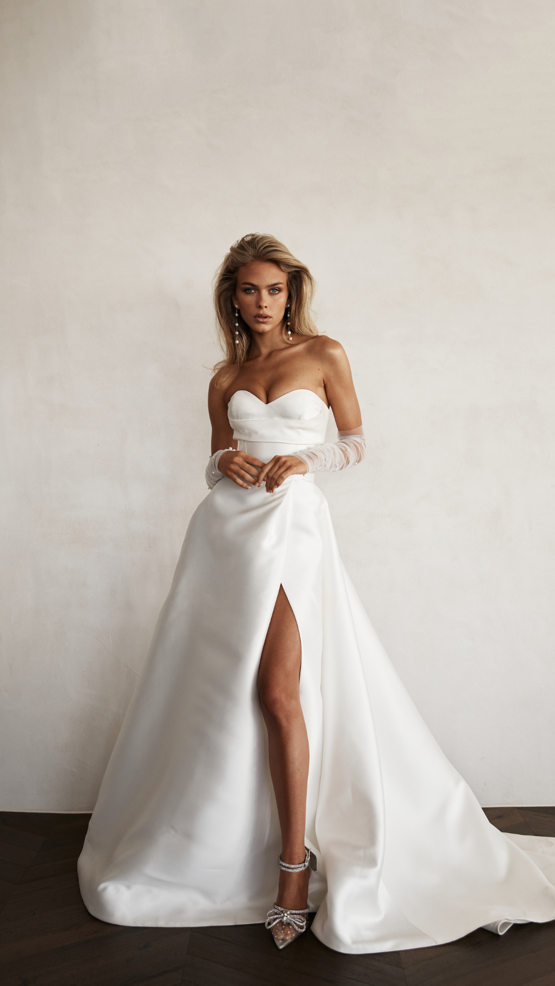 Bride wearing sweetheart classic ballgown with slit. 